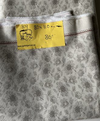 Ljust tyg med gråbeige blommor