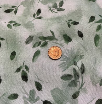 Ljusgrönt tyg med blad och blommor