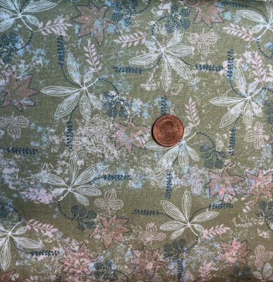 Grönt tyg medblommor och blad